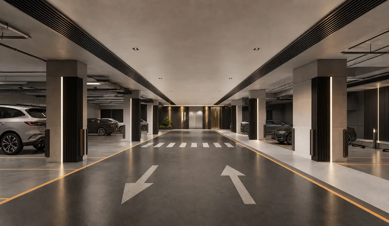 Orderly basement parking aisle with monochrome finishes and warm wayfinding lines